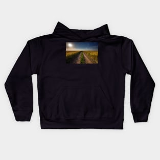 Rural road through wheat field Kids Hoodie